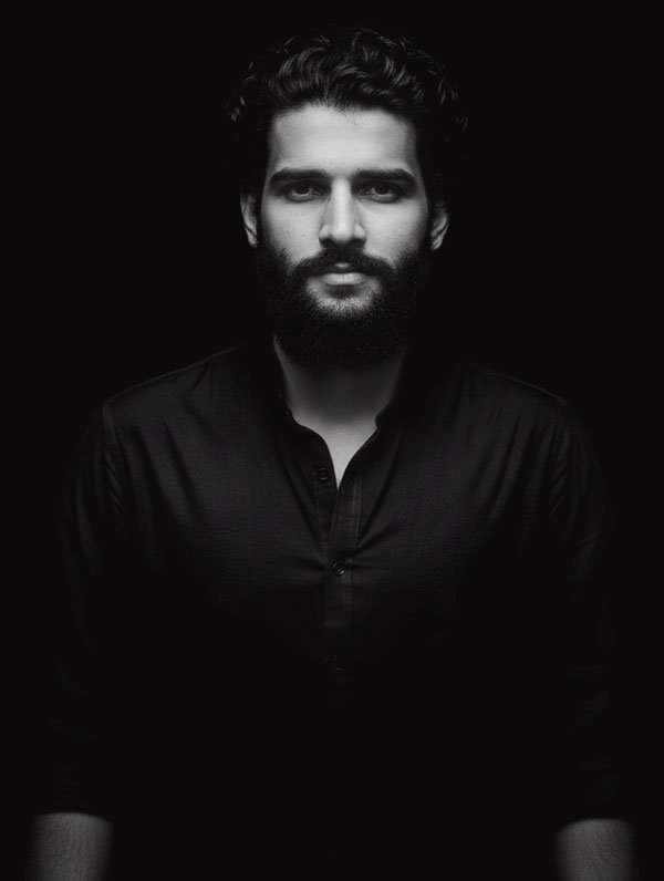 tahseen qamar, man standing portrait image in black
